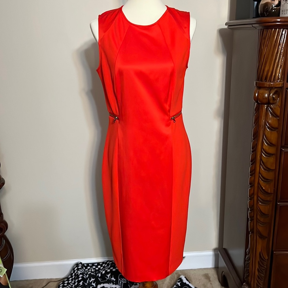 Bright bold orange sheath dress with rear split
